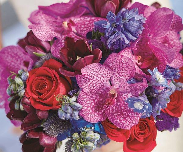 Aruba Wedding Bouquet by Shar Chatram flowershop: Magenta Orchids, Red Roses, Burgundy Tulips, Violet Delphiniums, Lavender Statice, Steel Blue Eryngium